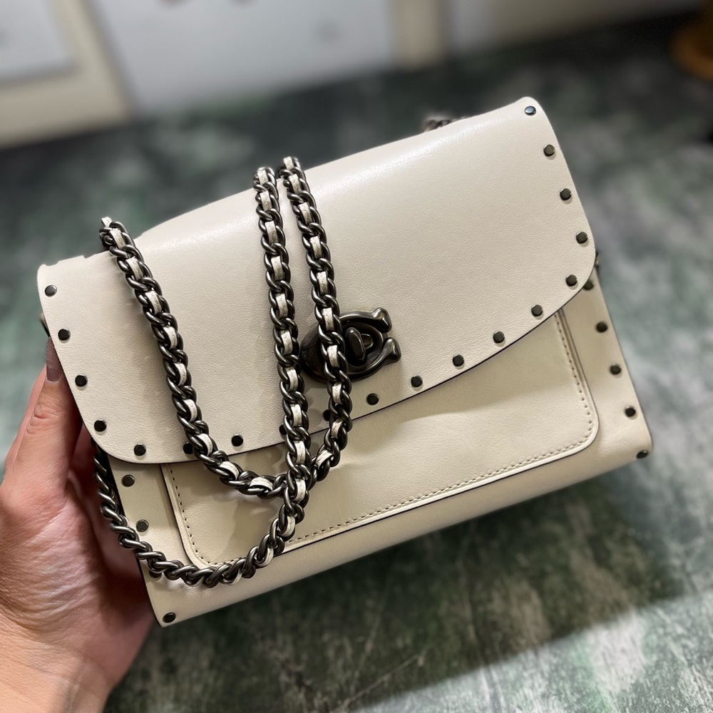 Coach Parker white leather with gunmetal tea rose rivets.